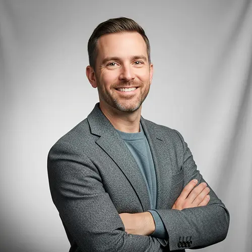 Studio portrait of Brian E. Morgan standing with arms crossed on a light gray background for GLP1Rating